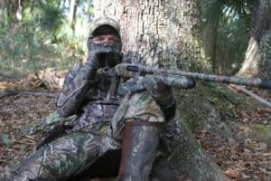Stay ready. Keep your mask and gloves on, and keep your gun propped up on your knee. Late-season gobblers often slip in quietly, never making a peep as they approach.