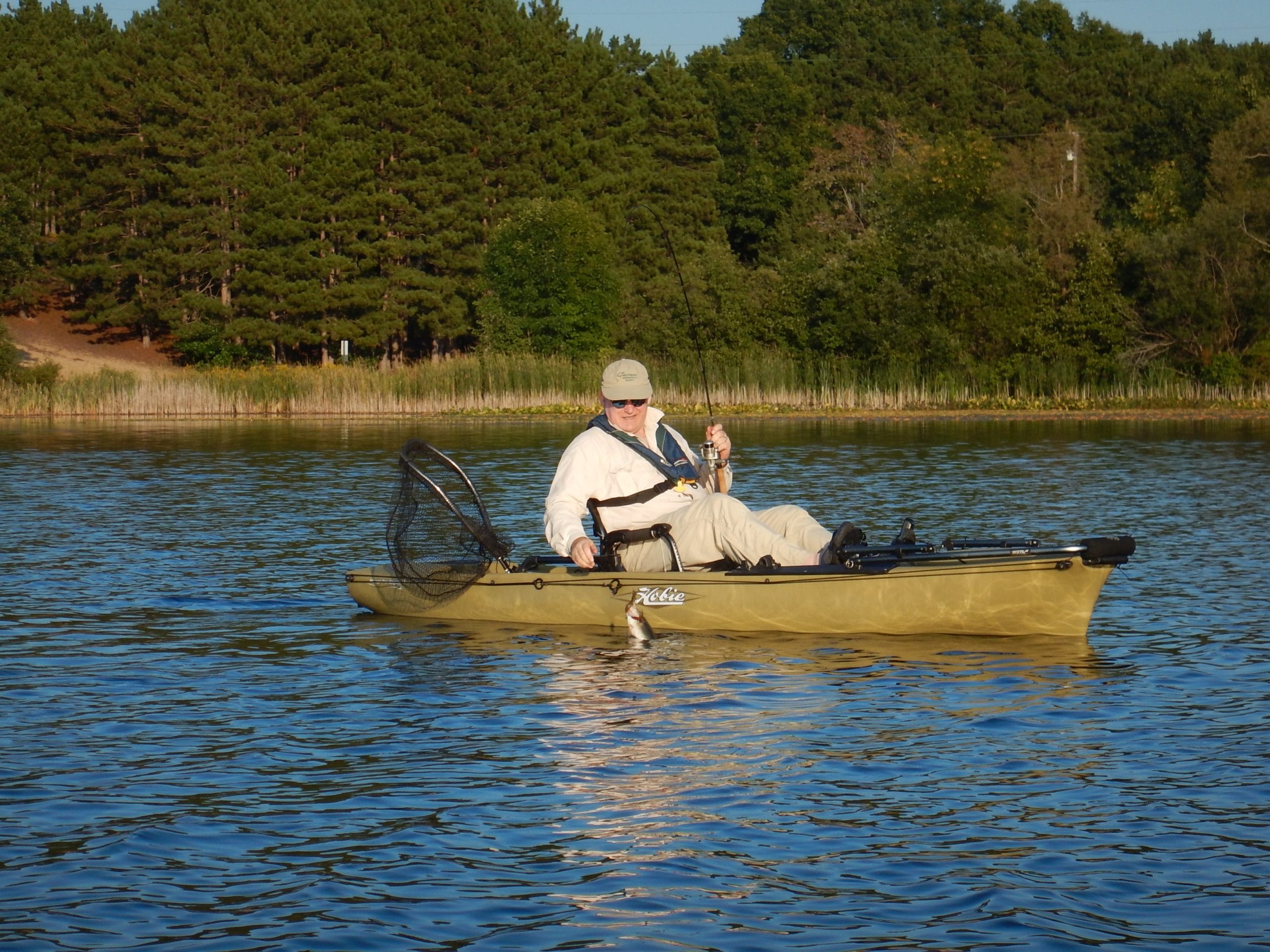 This 12-foot kayak has its rod holders removed while the angler casts for bass.