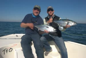 The author (pictured on the left) touts the sheer adrenaline rush of fishing for false albacore.