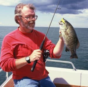 Noted Cleveland, Ohio outdoor writer D'Arcy Egan holds a chunky, but not unusual Lake Erie smallmouth bass caught from the Bass Islands area.