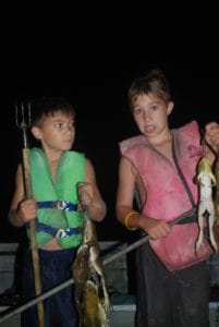 Raise 'em right. Lance and Gavin Yabarra are already expert frog giggers.
