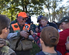 Mike Ganz gives youth an up-close look at a pheasant.