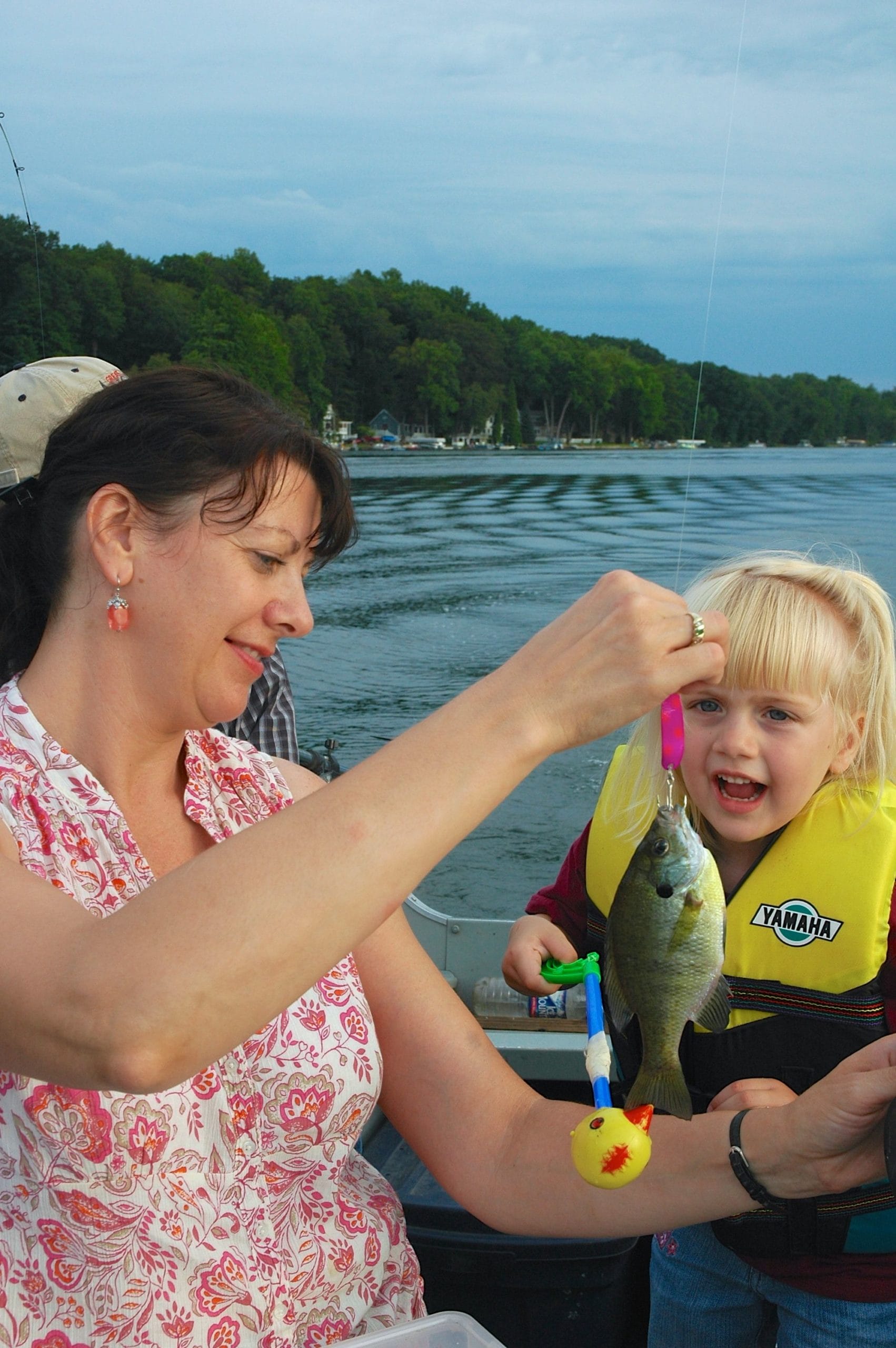 Trolling for bluegill is a great technique for kids to get in on the action. Here, Kathy Terpstra and Andrea Essenburg admire a bluegill Andrea reeled in after it hit a small Stinger Scorpion spoon trolled with a downrigger on a Michigan lake.