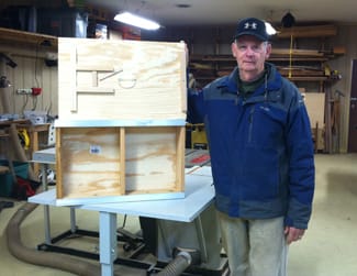 Donald Mullins shows the inside of a pheasant transport box.
