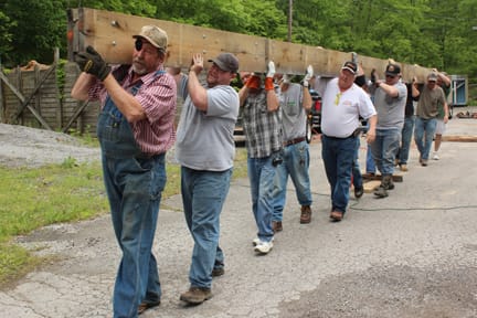 Volunteers from the Nashville Building & Construction Trades carry lumber to the site of walking bridge in the heart of Montgomery Bell State Park that was washed away in the 2010 floods.