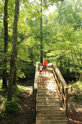 Patrons enjoy a stroll across the newly-constructed walking bridge at Montgomery Bell State Park, in Burns, Tenn.