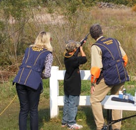 President Robinson and Mona mentor youth shooters at USA's Annual Get Youth Outdoors Day event.