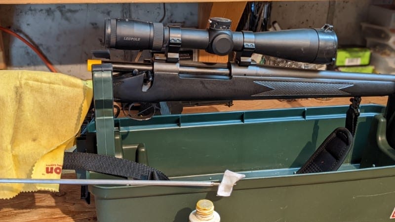 image: rifle in cleaning cradle with rag