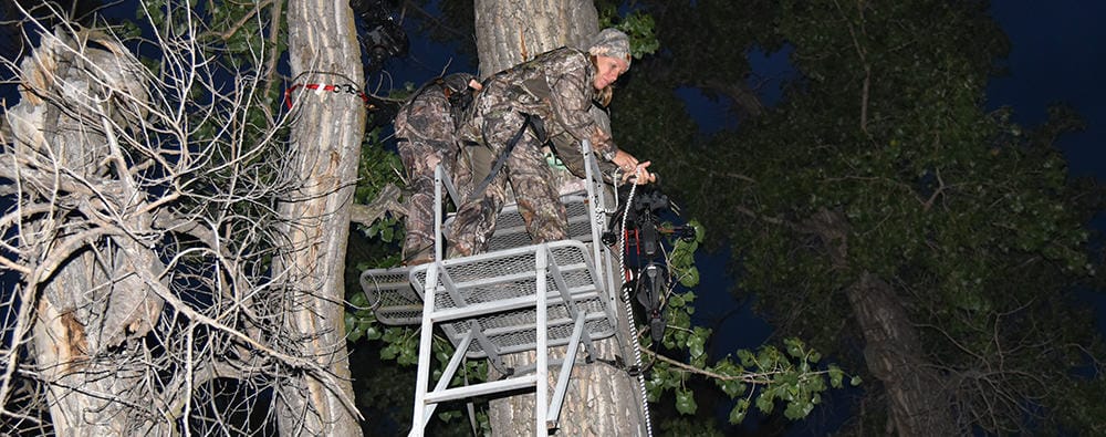 image: female hunter in treestand