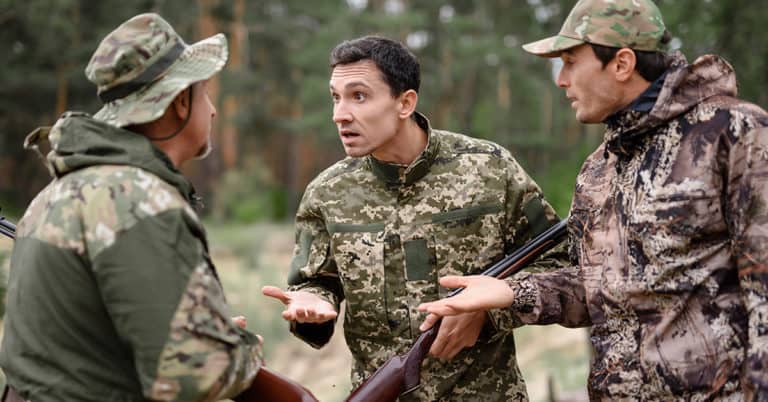 Hunters,Stand,In,A,Circle,And,Talk,About,Hunting,With