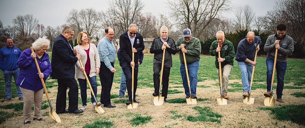 image: group of people with shovels for groundbreaking