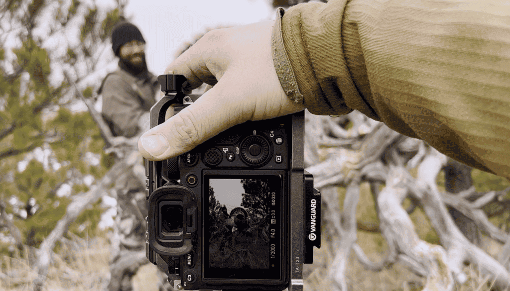 image: holding a camera taking a photo of successful turkey hunt