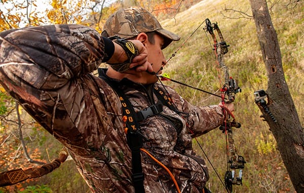 image: archery hunter in treestand