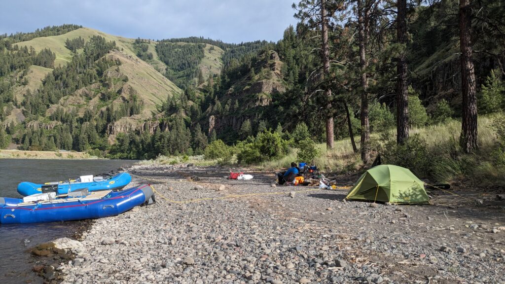 Camping along a river while rafting in the Rocky Mountains