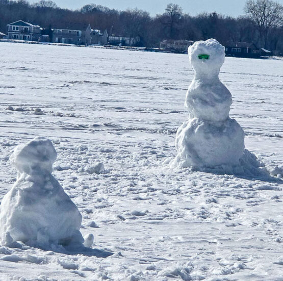 Snowmen built by Minnesota Take Kids Ice Fishing participants
