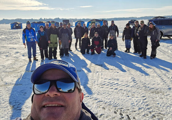 Take Kids Ice Fishing volunteers pose for a picture.