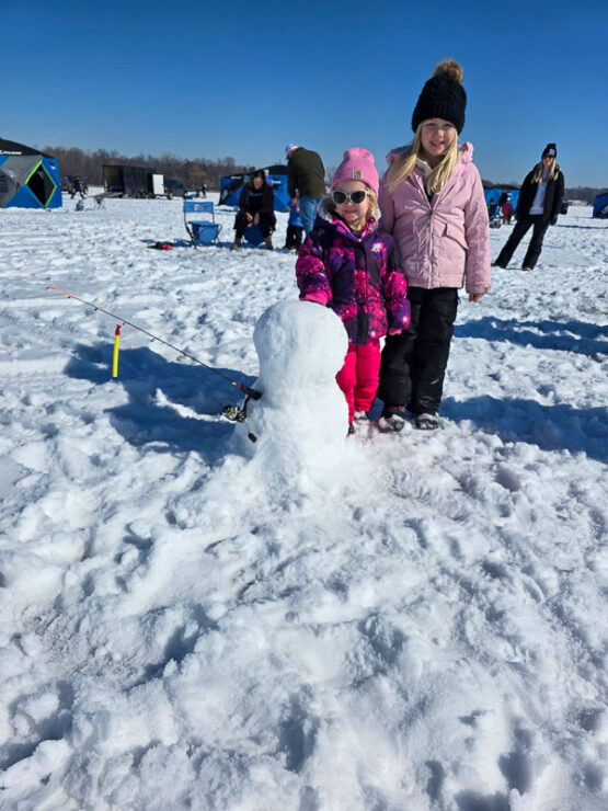 Take Kids Ice Fishing participants build a snowman.