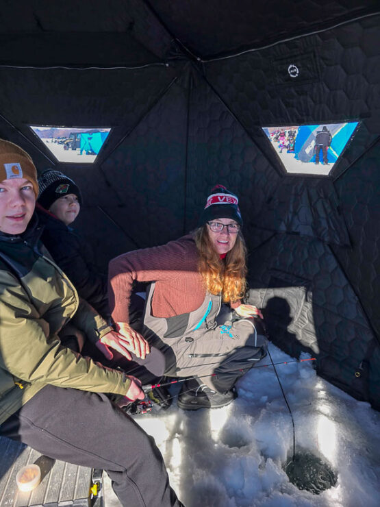 A Minnesota family ice fishing at Lake George Regional Park.