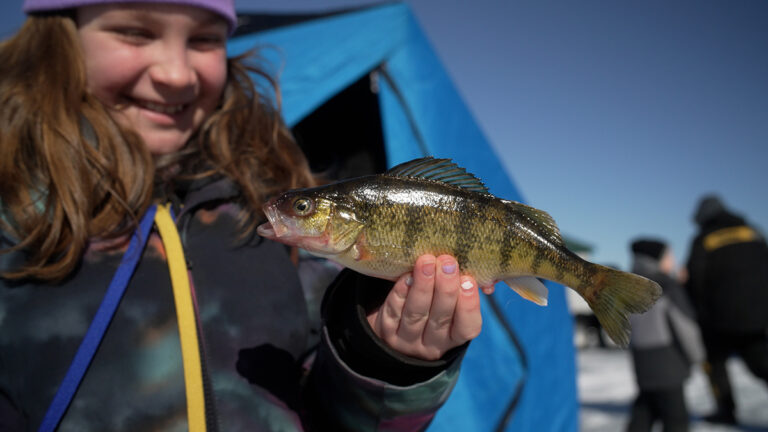 Youth angler holding up a fish