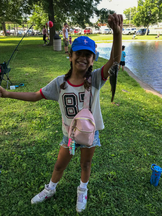 Youth with fish at Take Kids Fishing Day