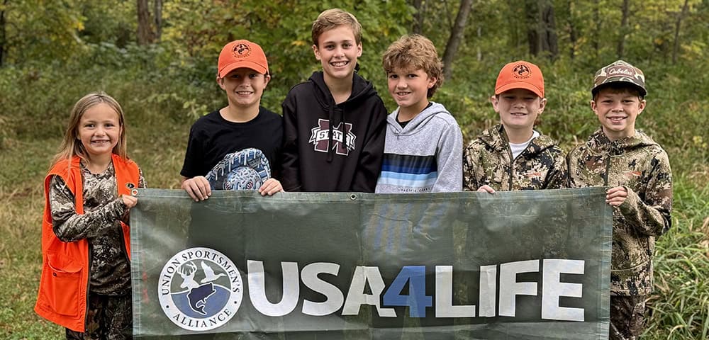 image: group of kids holding USA4Life sign