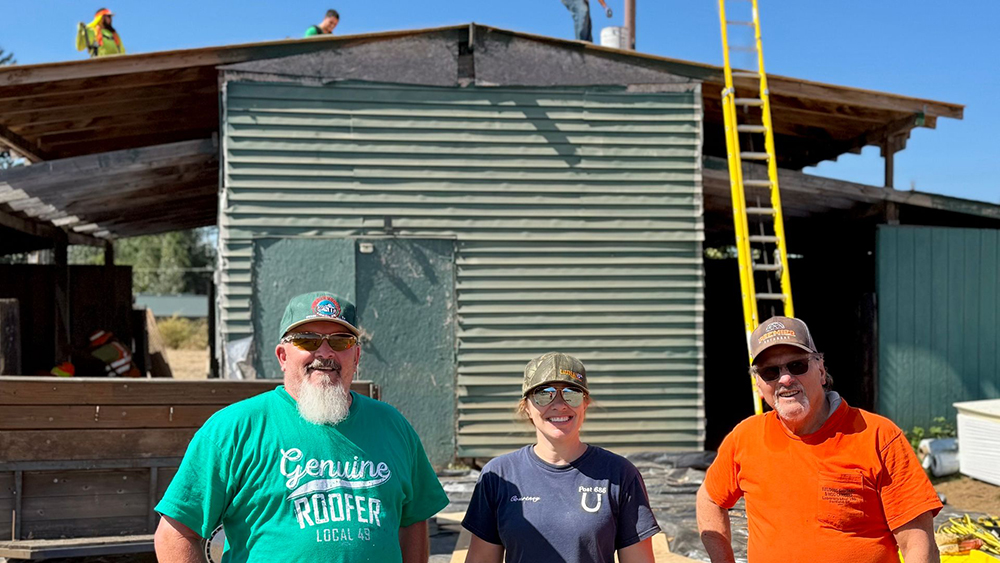 image: volunteers in front of barn