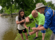 Union volunteers help a youth angler reel in a fish at the Lexington Take Kids Fishing Day.