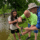 Union volunteers help a youth angler reel in a fish at the Lexington Take Kids Fishing Day.
