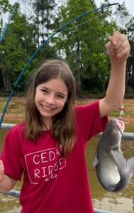 image: girl holding catfish