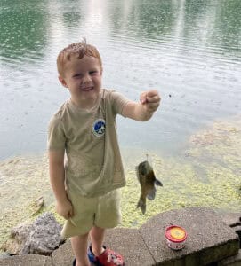 image: young boy with fish