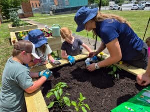 Maggie Sager and youth participants gardening