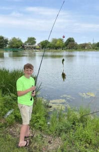 Boy catches fish at lake