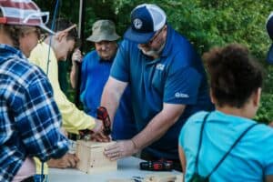 Volunteers help participants build birdhouses during the 4th Annual Flint Area Get Youth Outdoors Day.